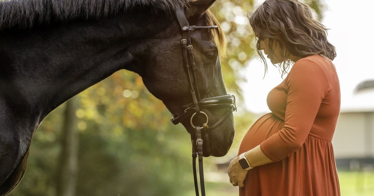 a pregnant woman with black horse