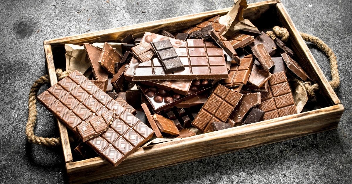 broken chocolate bars on wooden tray
