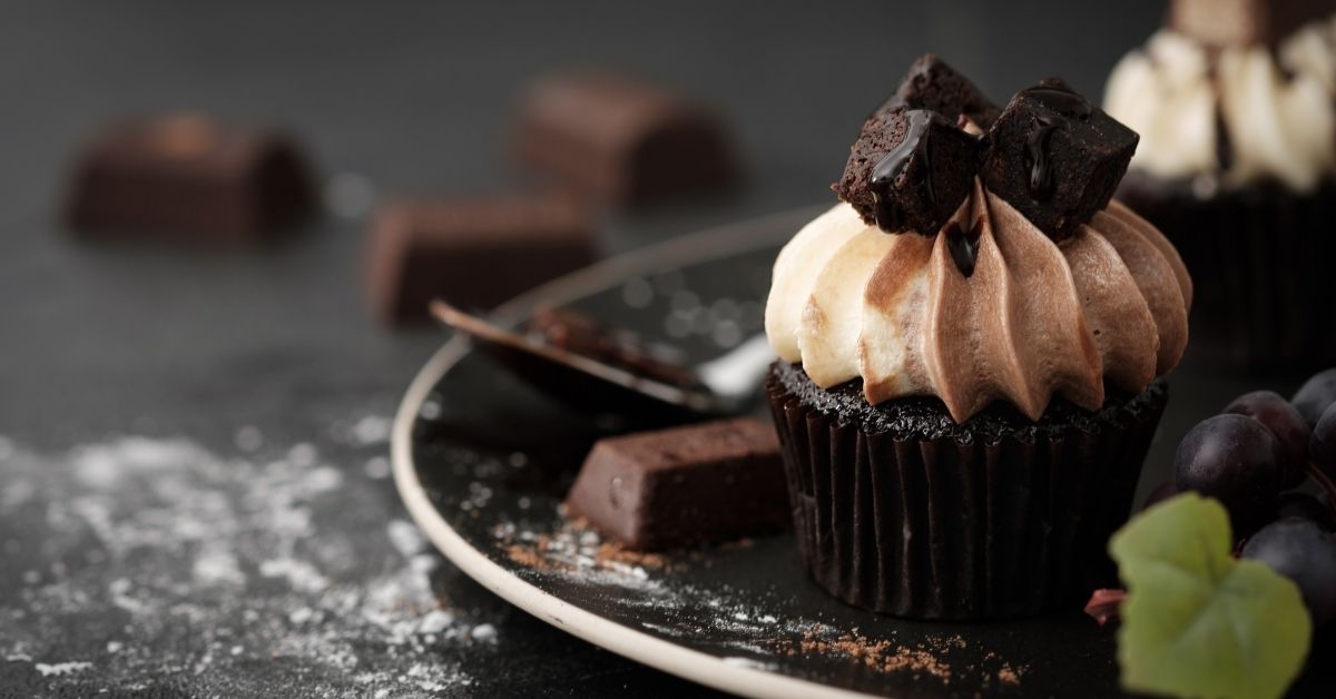 chocolate cupcake with icing and chocolate bar