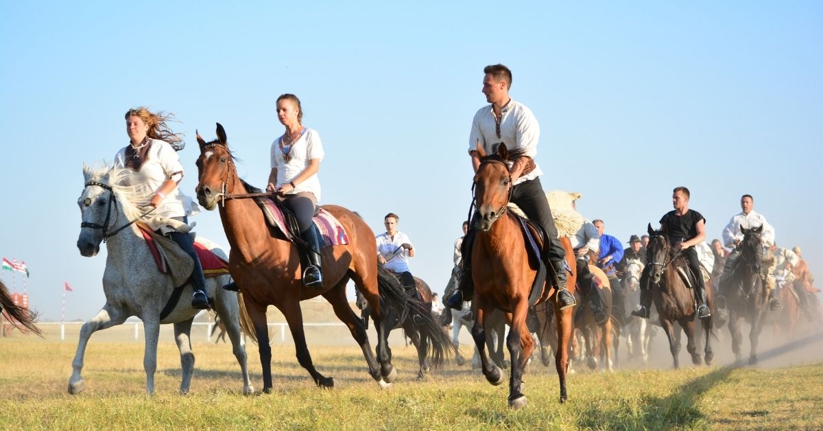 A group of riders are riding horses