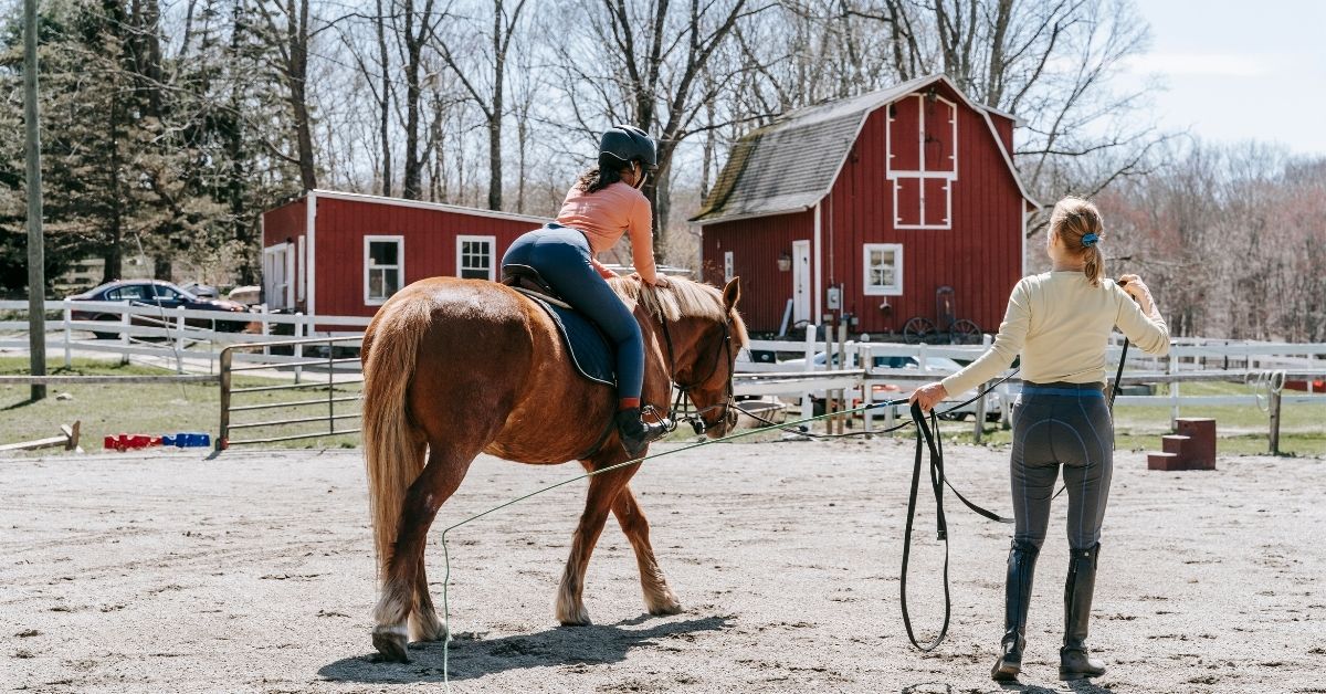 jockey women training with horse