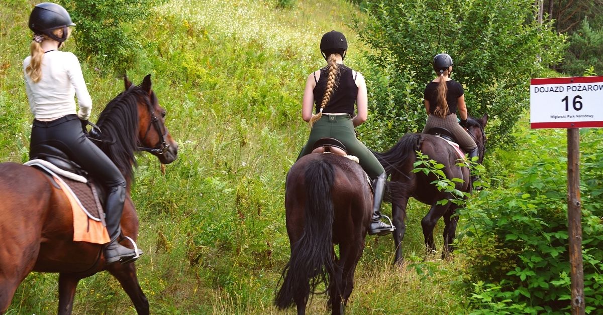 three girls at horseback riding lesson